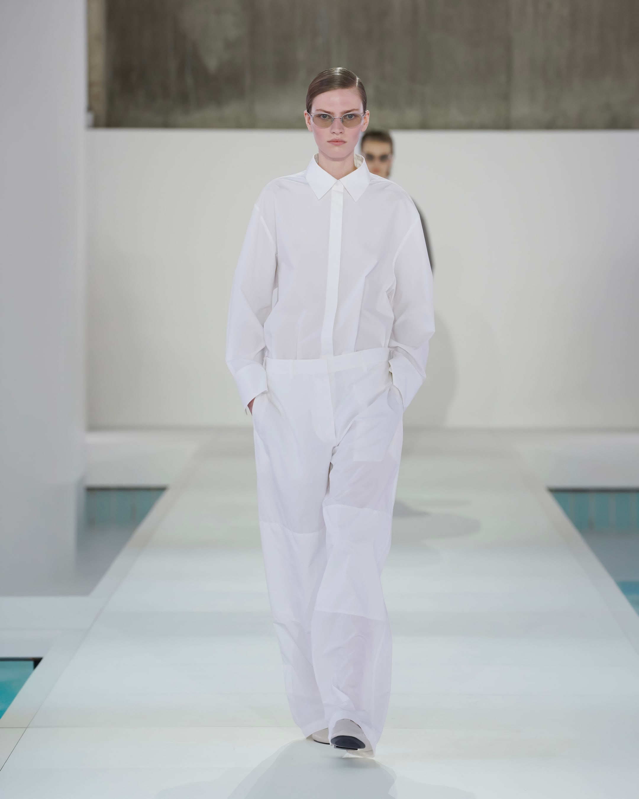 woman in white shirt and white trousers