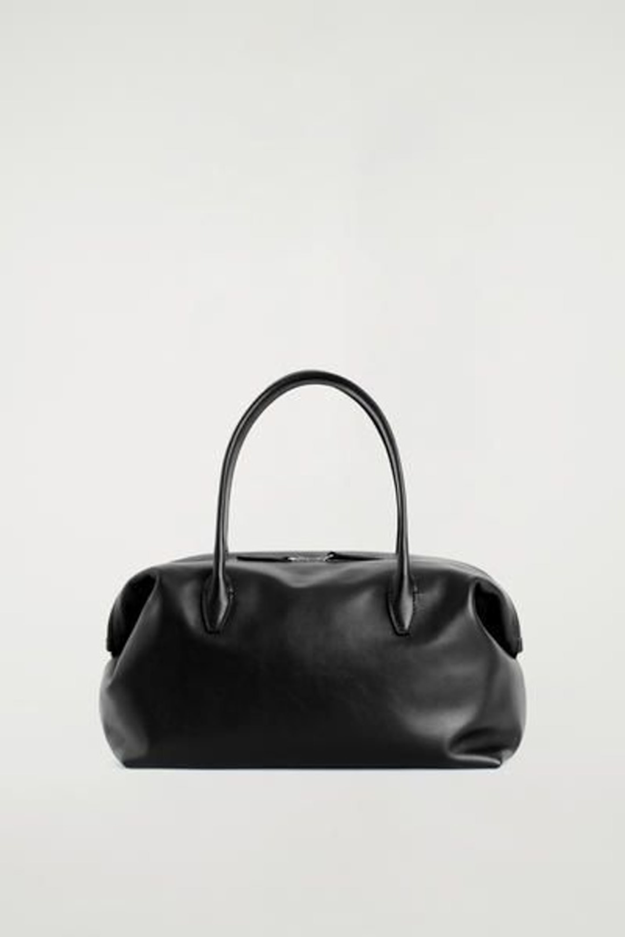 Black leather handbag with two handles, displayed against a plain white background.