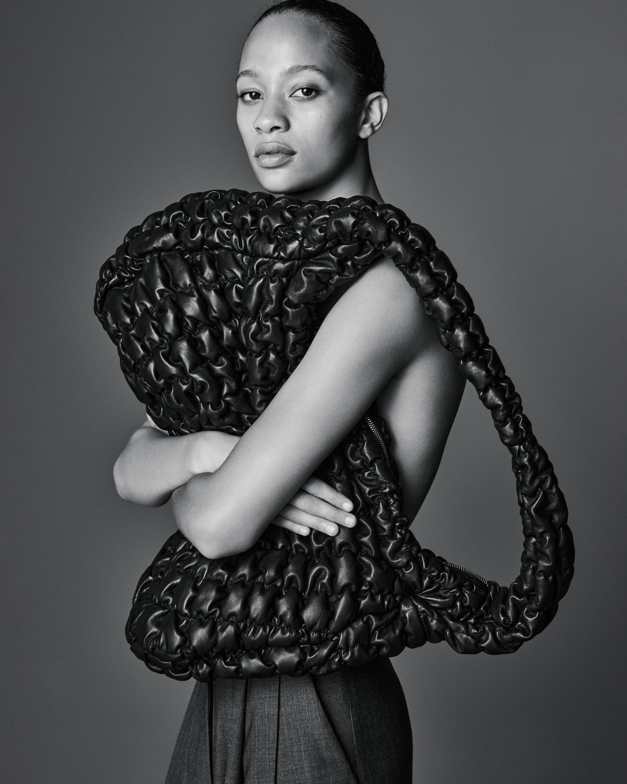 Woman holds leather quilted bag