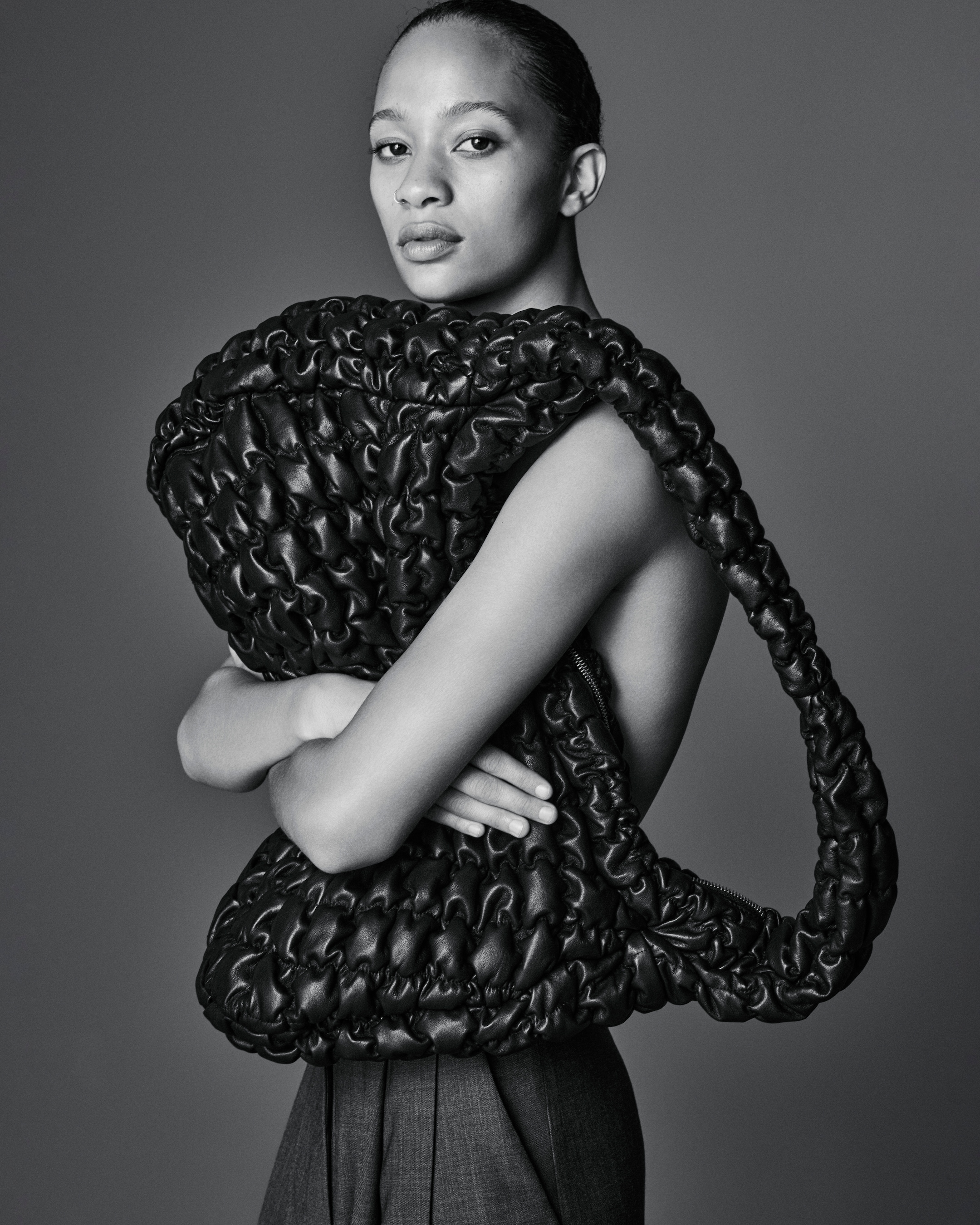 Woman holds leather quilted bag
