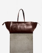 Placeholder for: leather bag on plinth