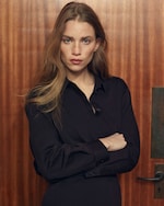 Placeholder for: Woman with arm crossed in shirt