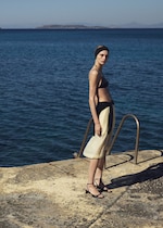 Placeholder for: woman in bikini top and yellow skirt