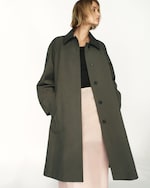 Placeholder for: Person wearing green coat and pink skirt