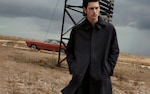 Placeholder for: Man wearing mid length black coat