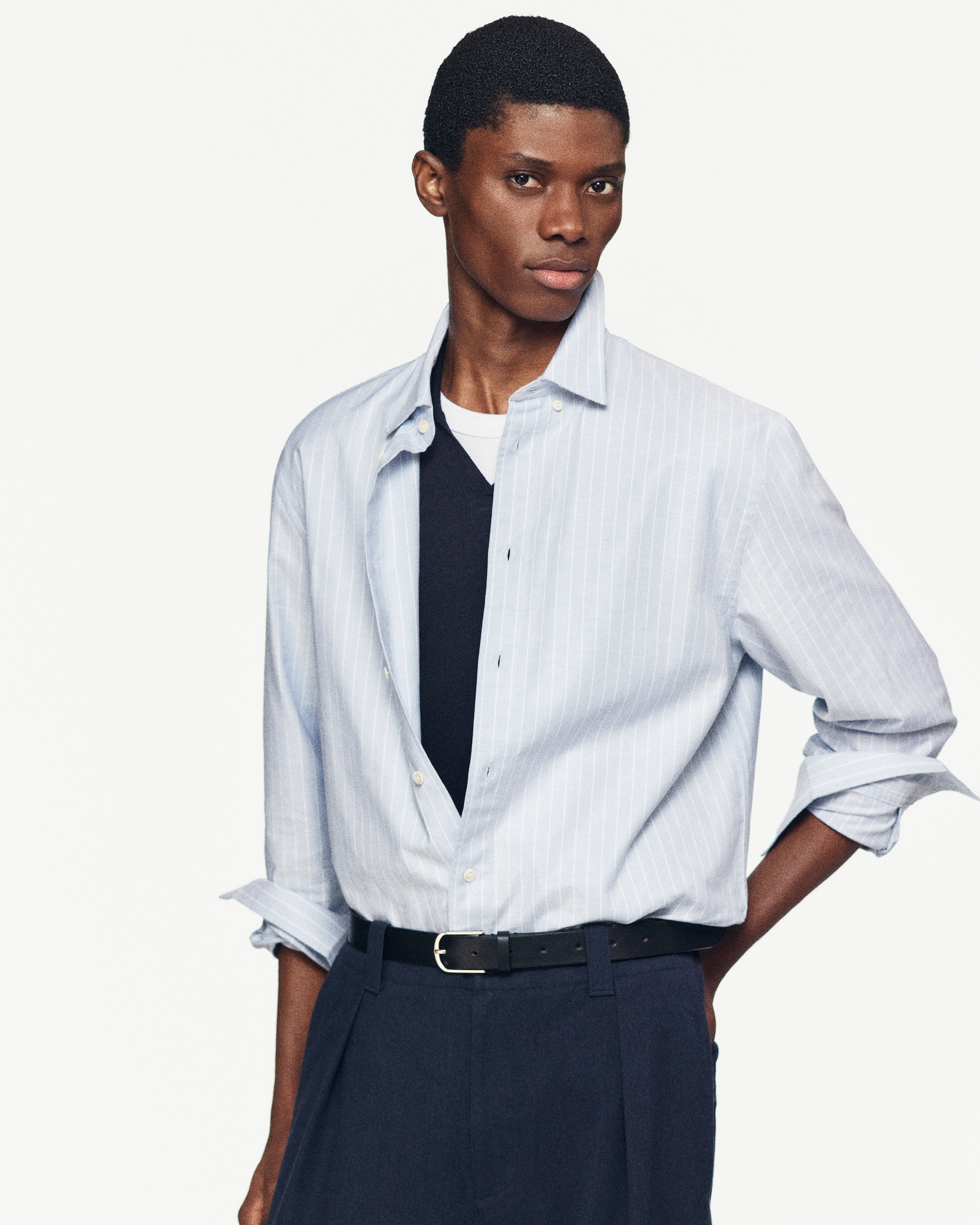 man wearing light blue stripes shirt