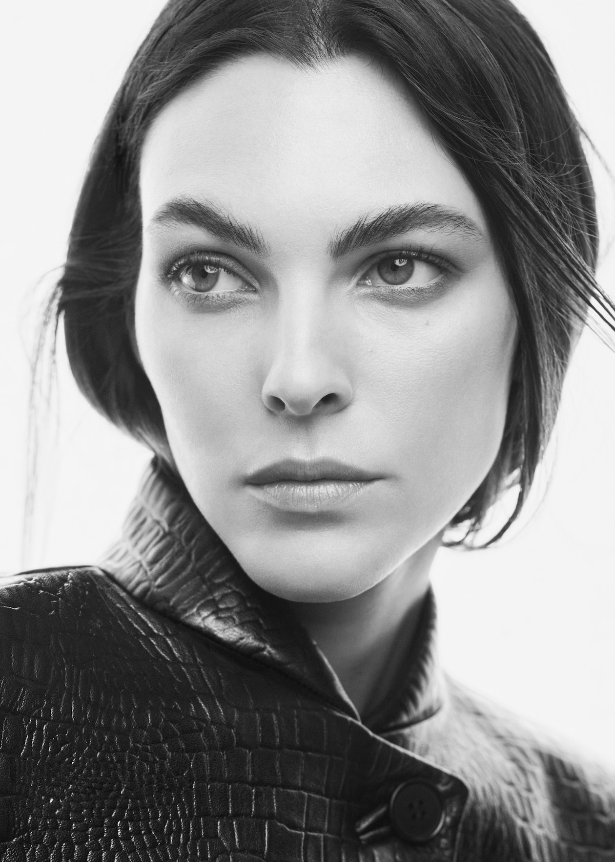 Woman looking at camera with leather jacket in black and white