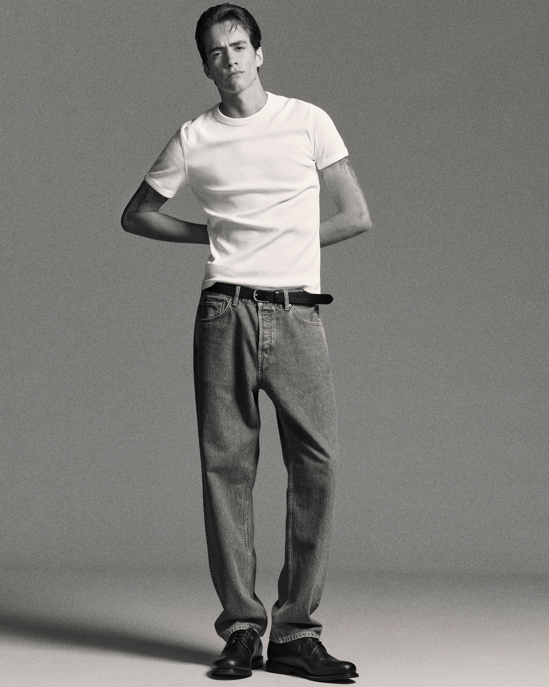 man in white tshirt with jeans and belt
