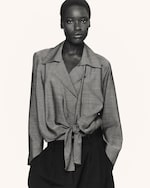 Placeholder for: Woman in tie waisted blouse