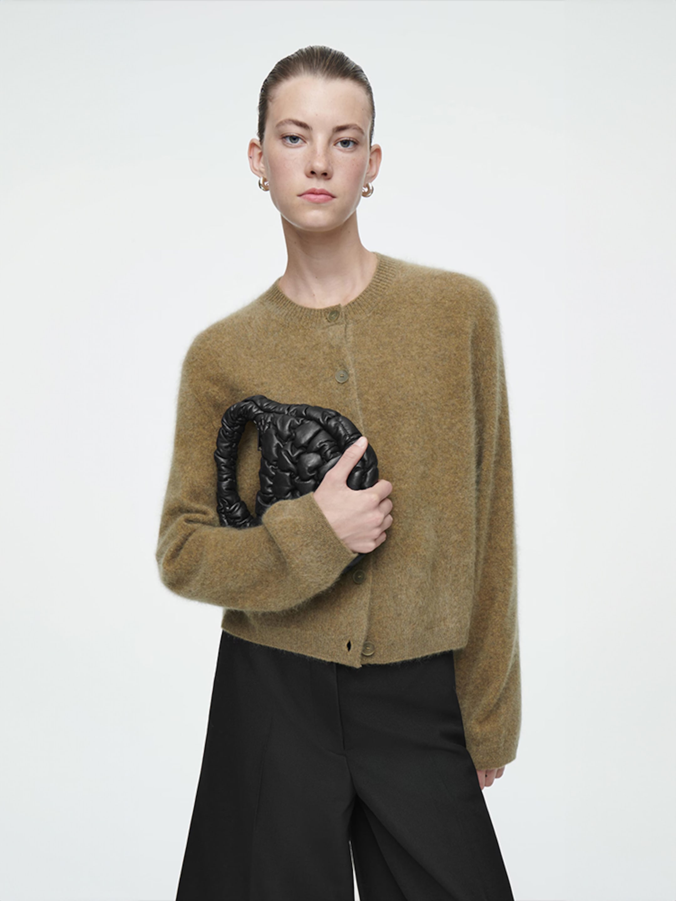 Person holding quilted bag