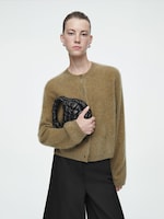 Placeholder for: Person holding quilted bag