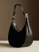 Placeholder for: Black curved handbag with gold zip and buckles