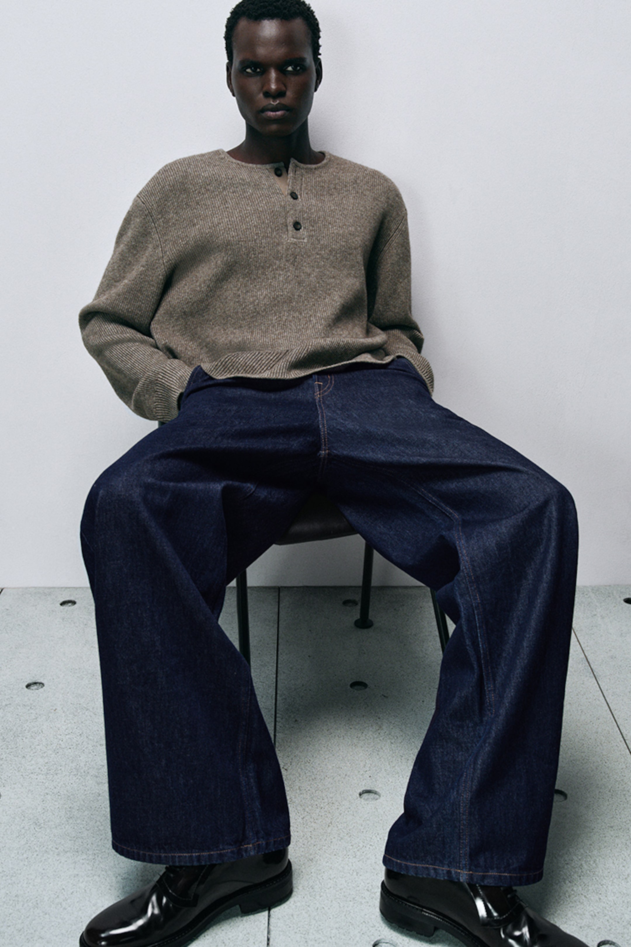 model wearing wide leg jeans and knitwear jumper