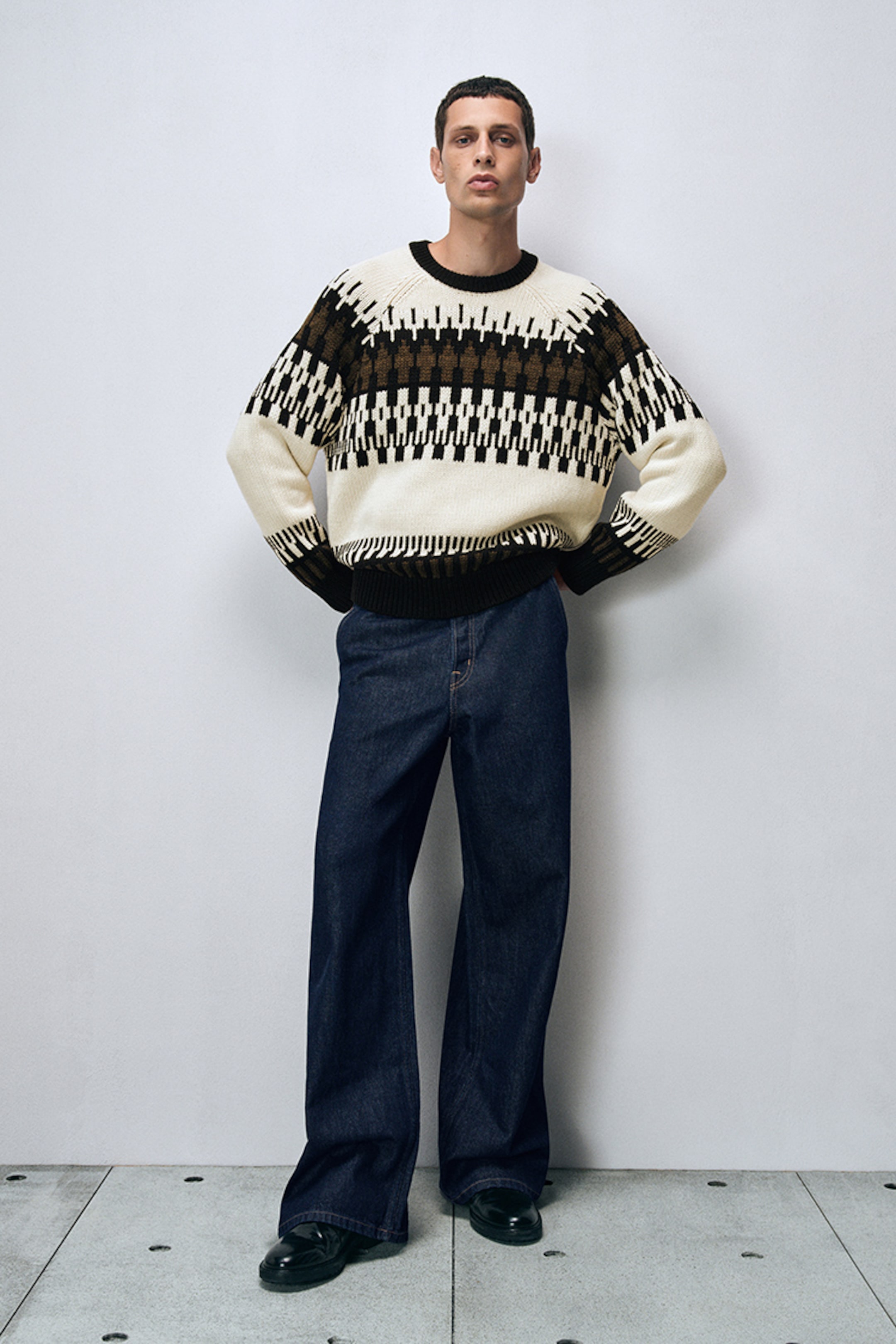 model wearing wide leg jeans and knitwear jumper