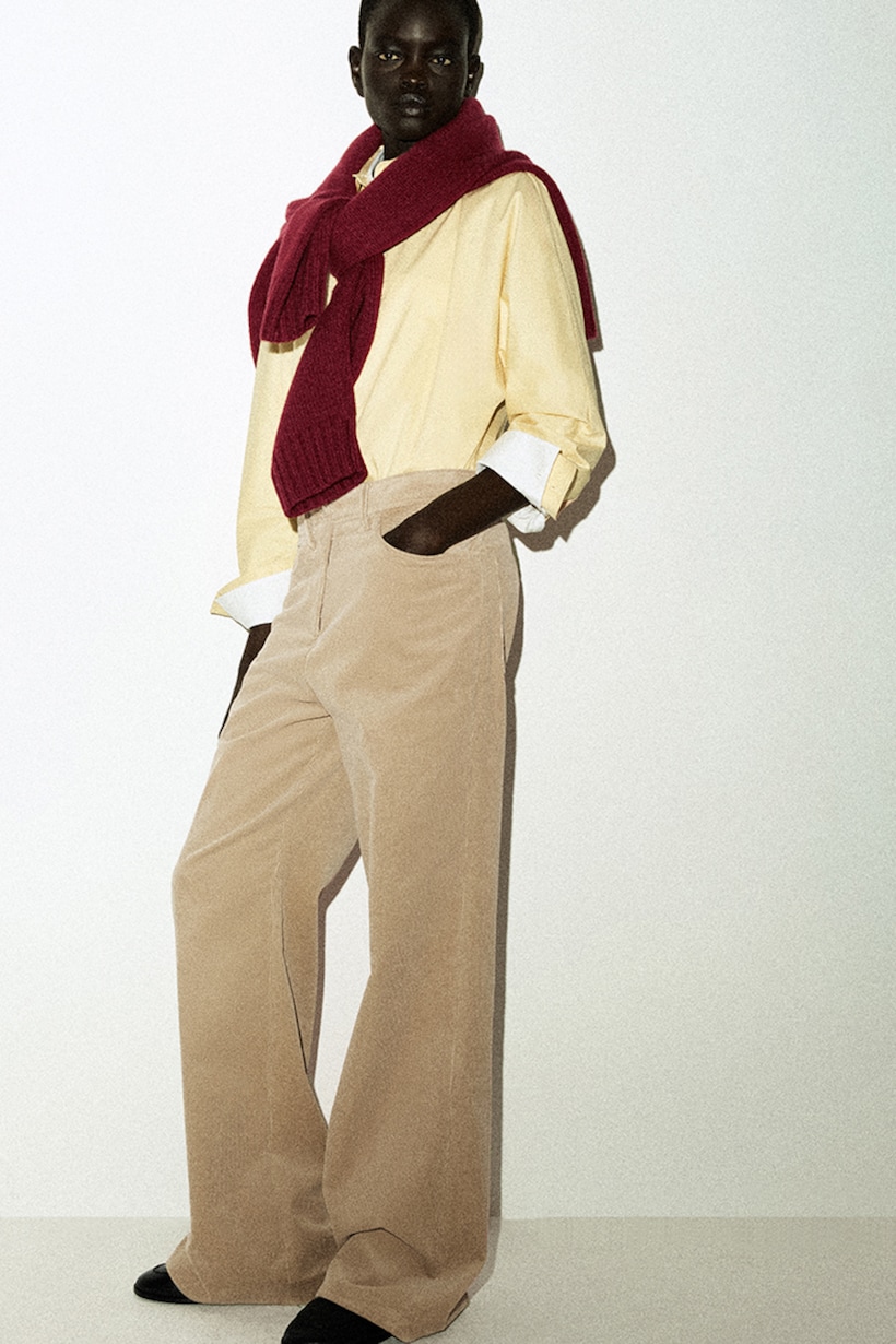 person wearing denim wide leg trousers