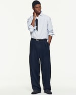 Placeholder for: man wearing light blue stripes shirt and relaxed navy trousers