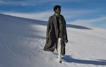 Placeholder for: Man wearing long wool coat and scarf