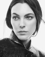 Placeholder for: close up of woman's face in croc leather jacket