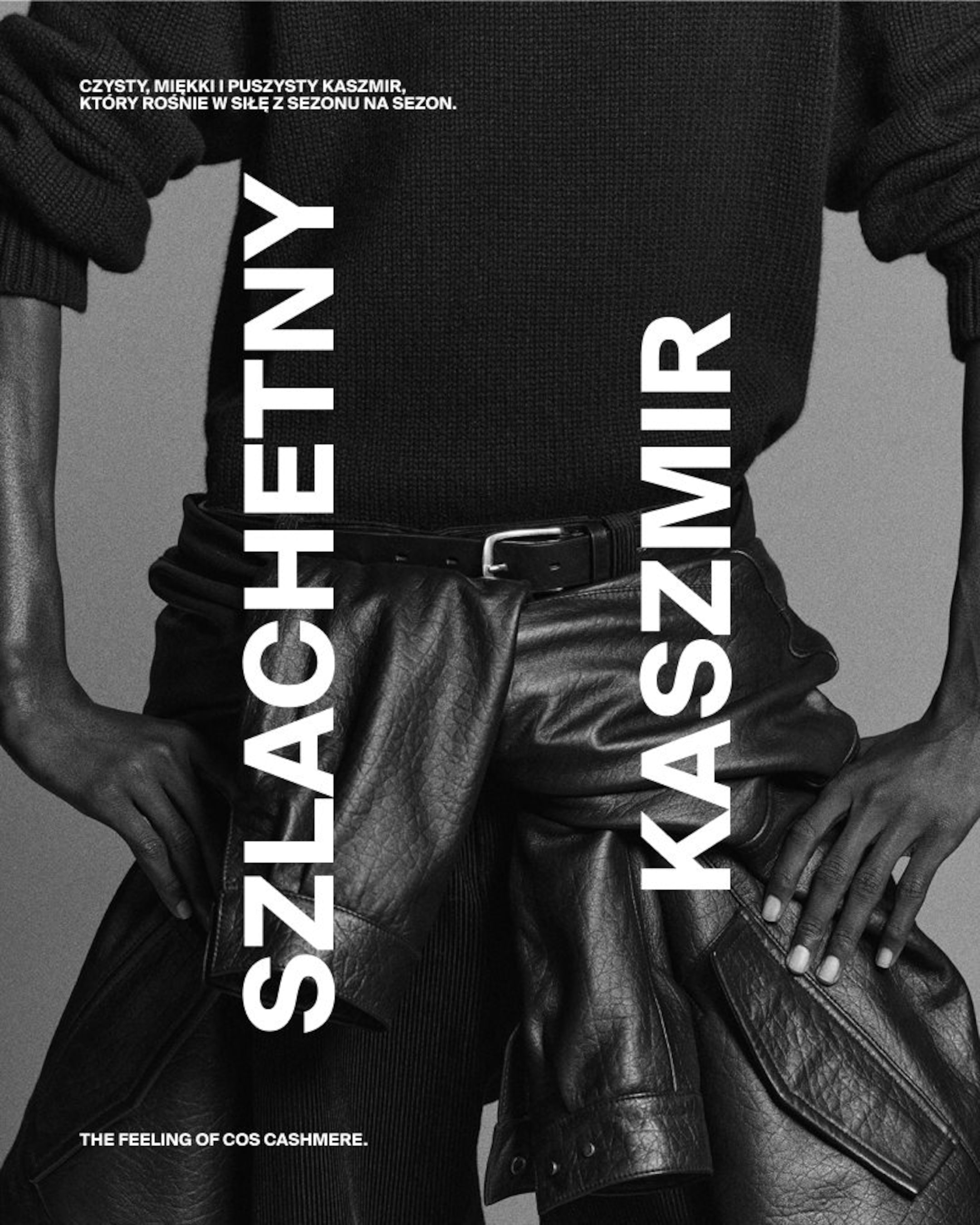 Person wearing a dark sweater with hands on hips, showcasing leather pants. Bold text in Polish and English highlights cashmere's appeal.