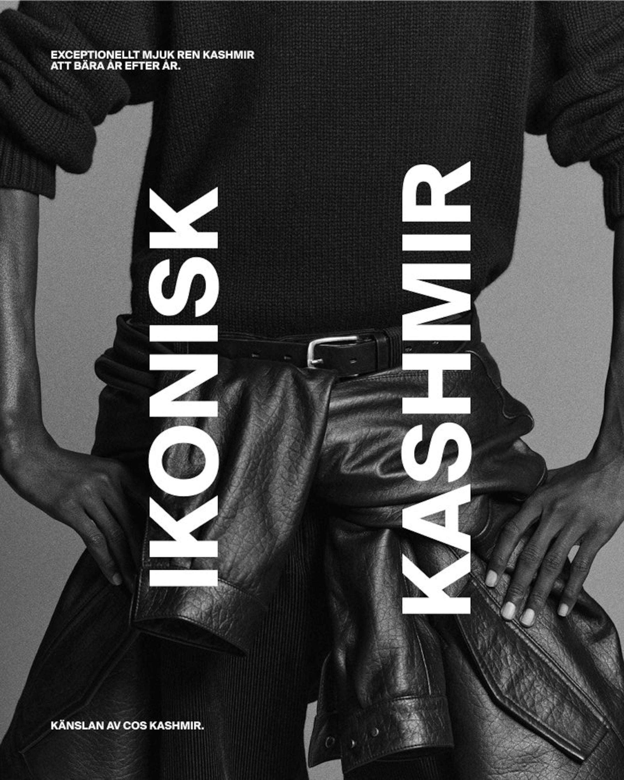 Black and white image of a person wearing a black sweater and leather pants, with bold vertical text "IKONISK KASHMIR" across the image.