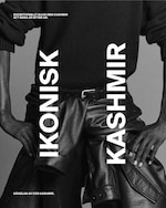 Placeholder for: Black and white image of a person wearing a black sweater and leather pants, with bold vertical text "IKONISK KASHMIR" across the image.