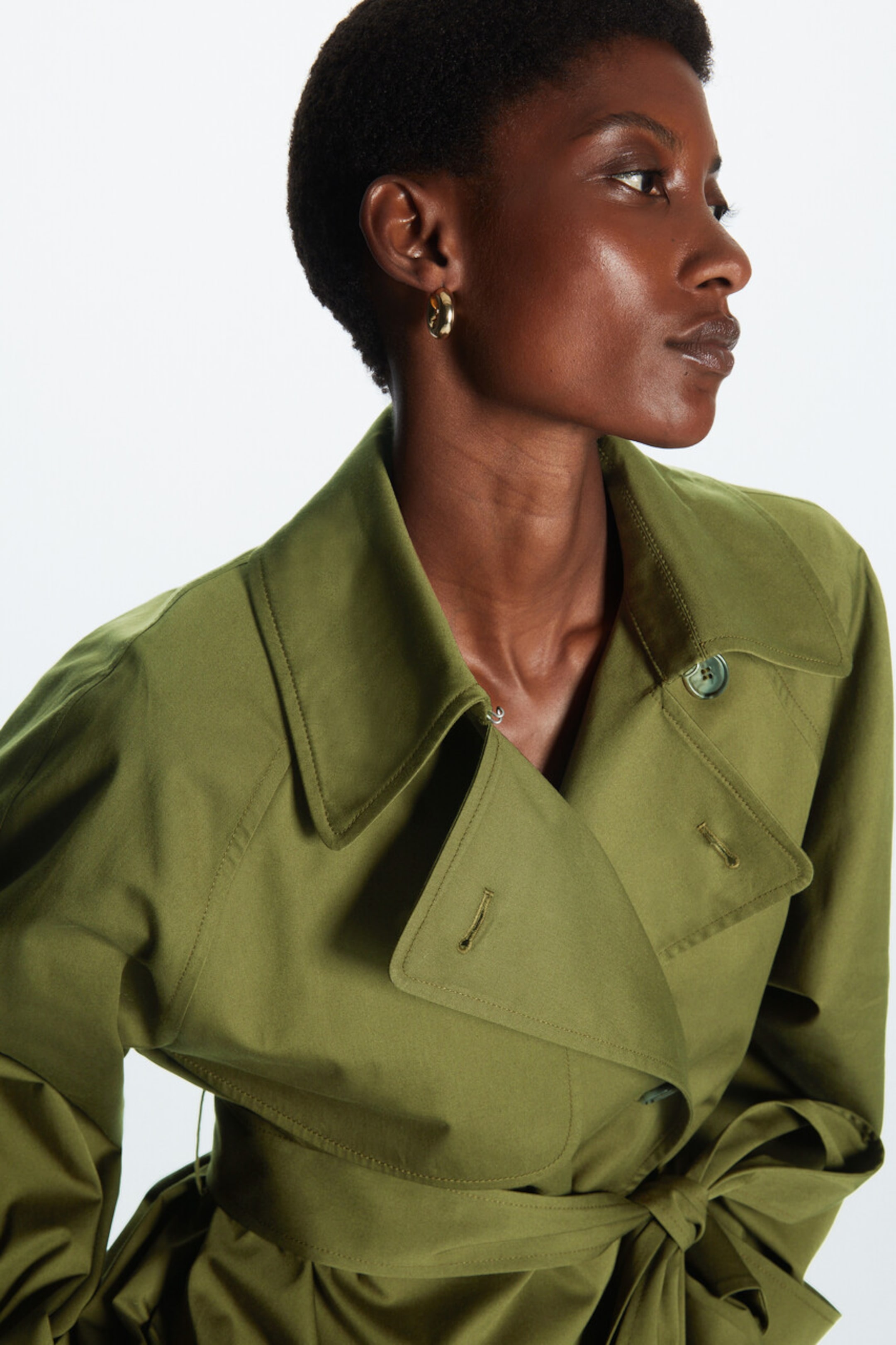 Woman wearing green trench
